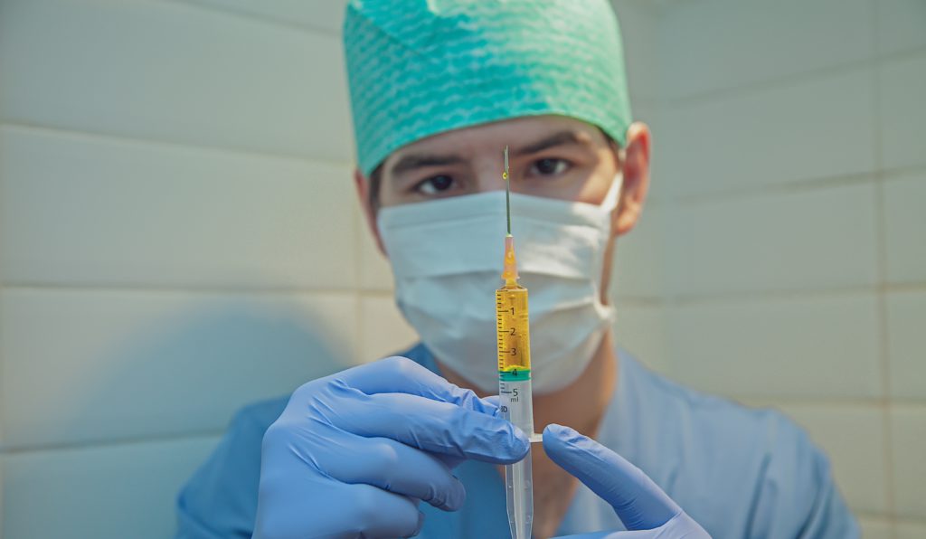 Nurse getting medicine ready for patient