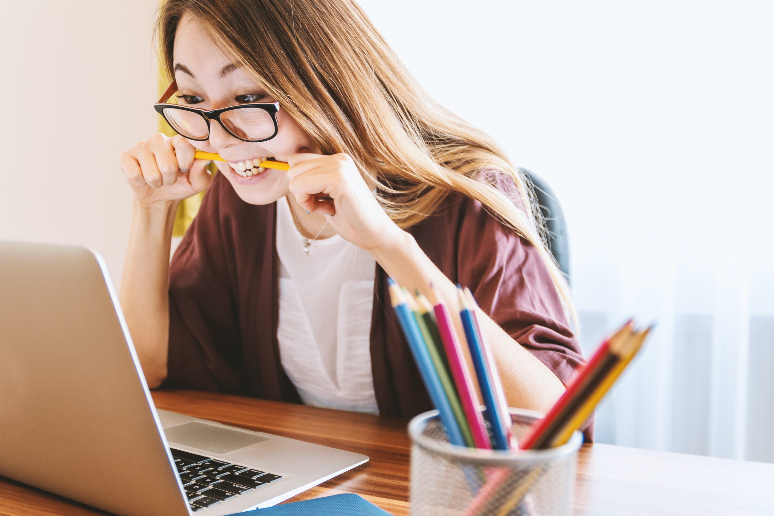 woman biting pencil Woman stress while studying for her NCLEX-RN Exam