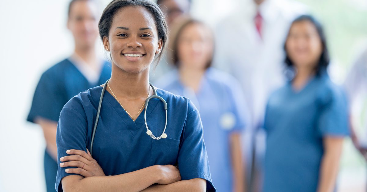 Nurse Practitioner standing with her arms crossed