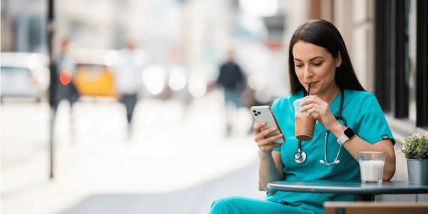 Home Page CNA drinking coffee outside of a hospital